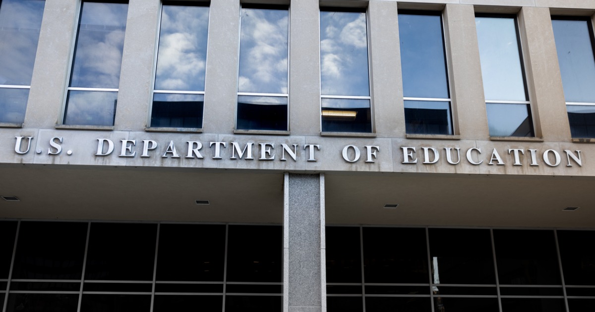 Partial image of Department of Education headquarters with department name on building.
